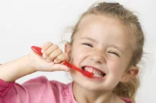 young girl brushing her teeth to Prevent Cavities