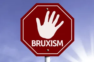 Stop sign with a hand and the word Bruxism