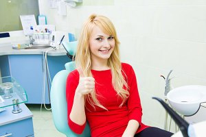 Young woman looking happy and giving a thumbs up